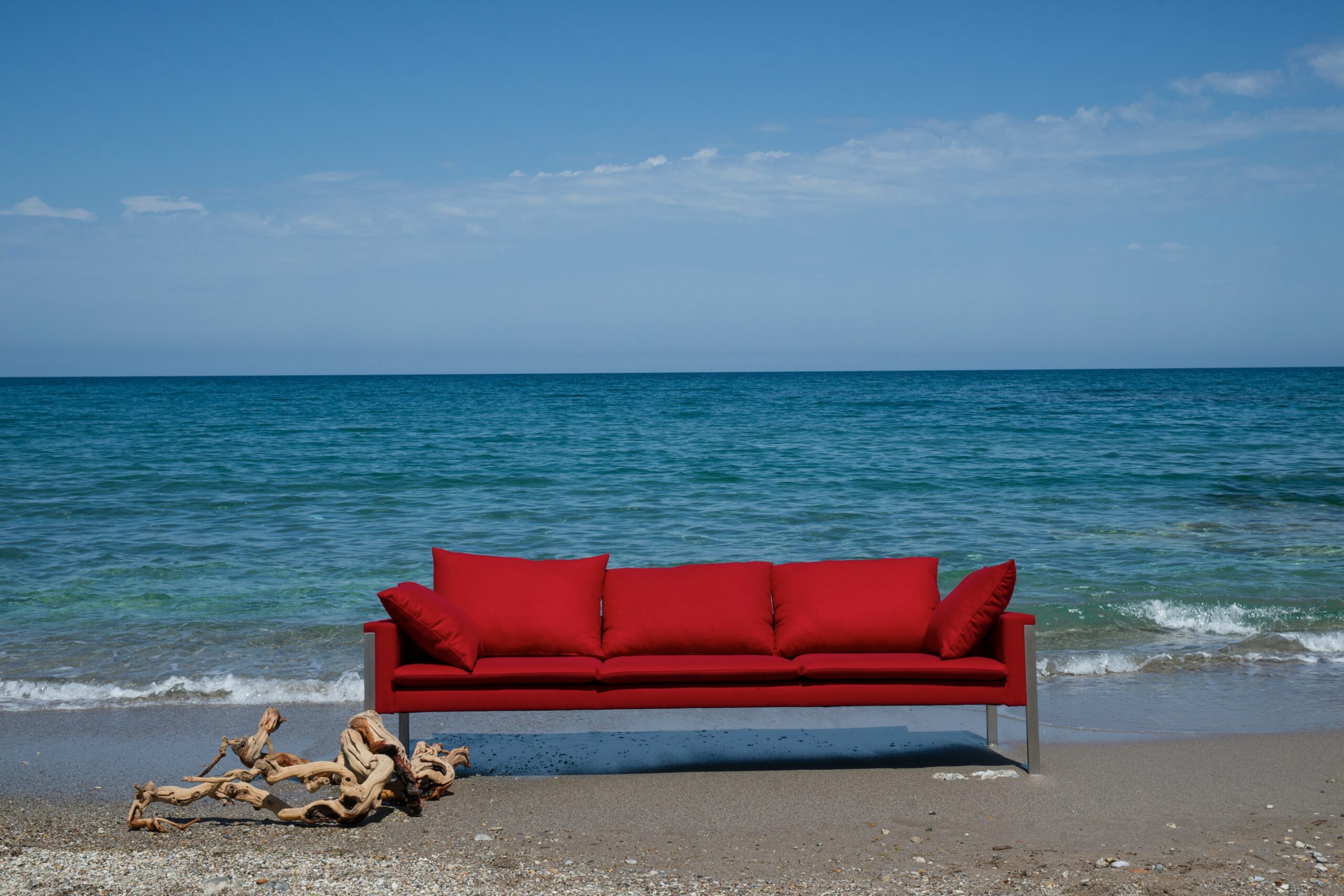 Red couch by the sea
