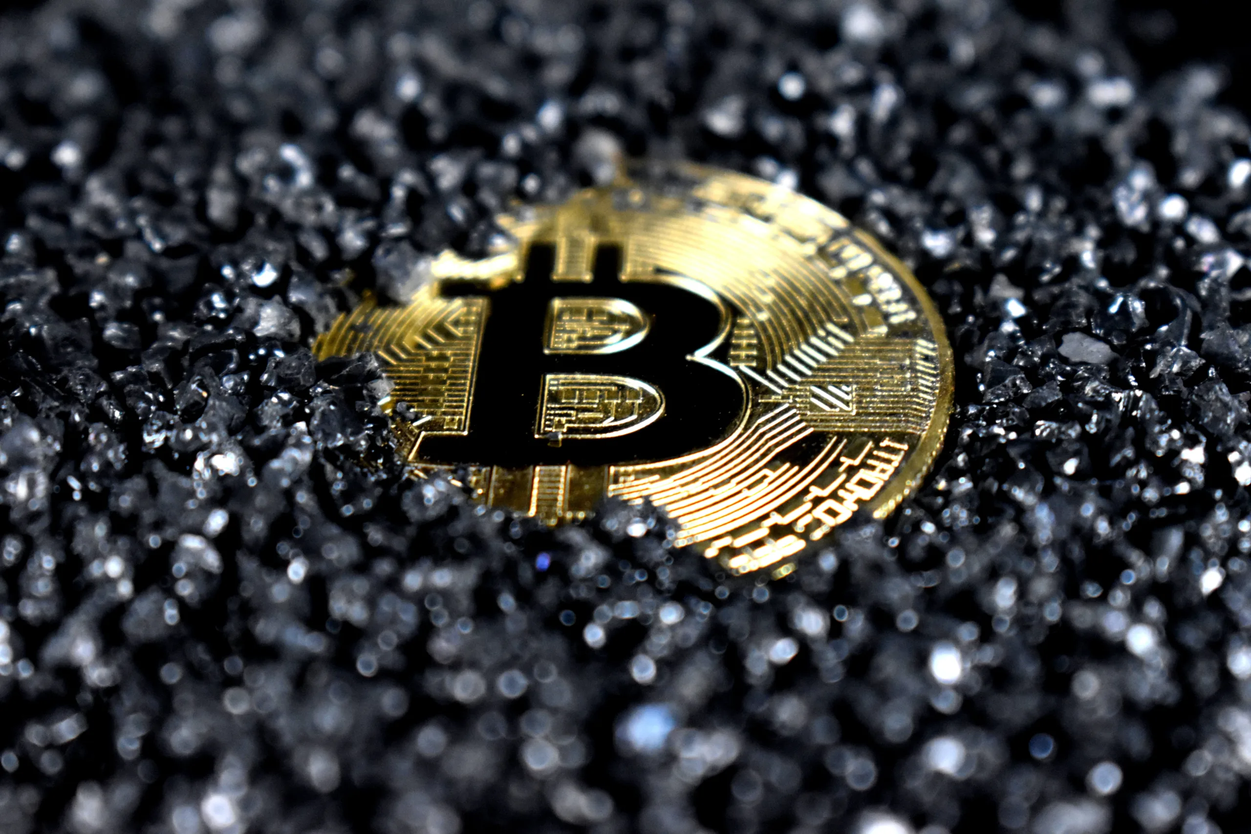 Bitcoin coin on textured surface