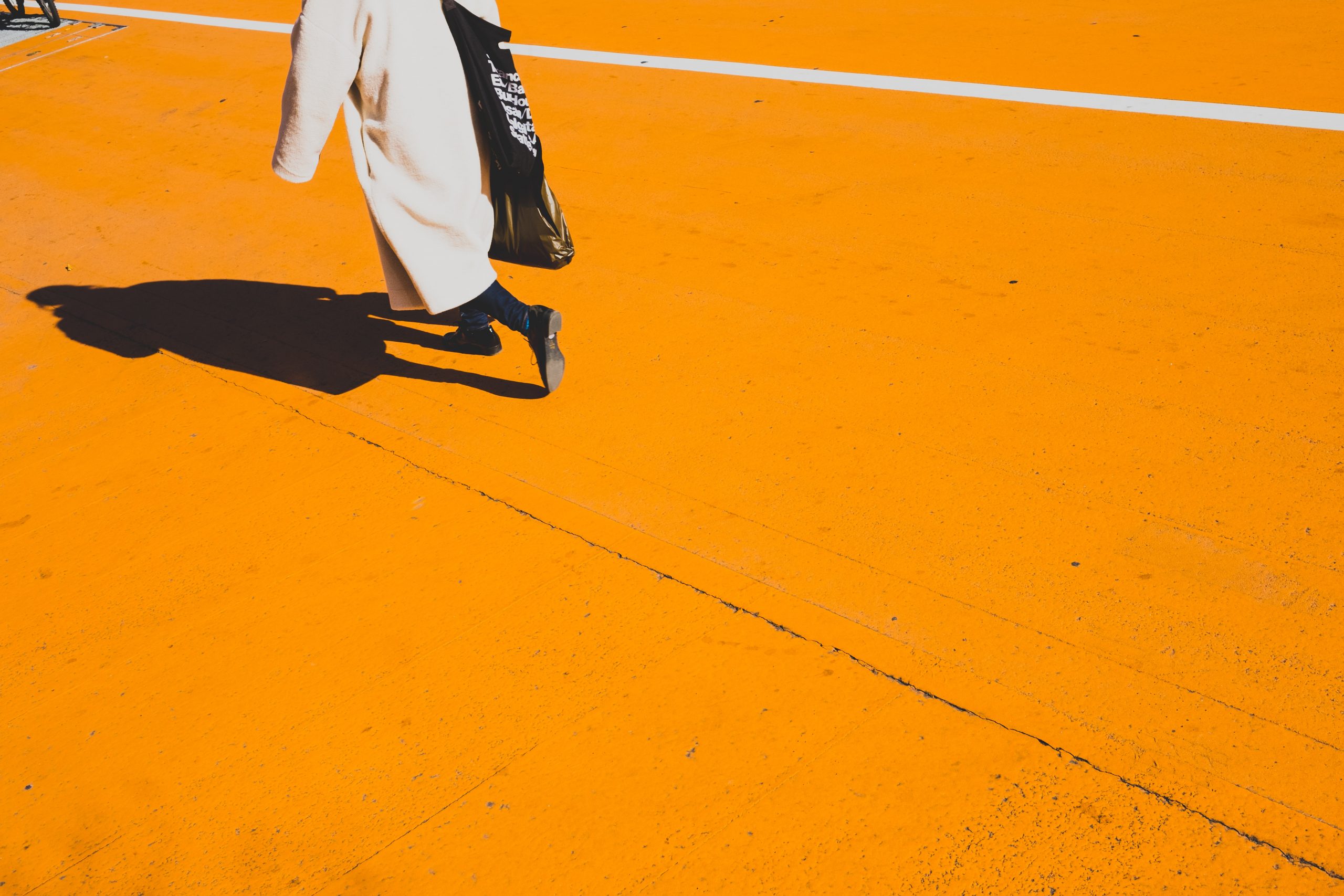 Person walking on orange surface